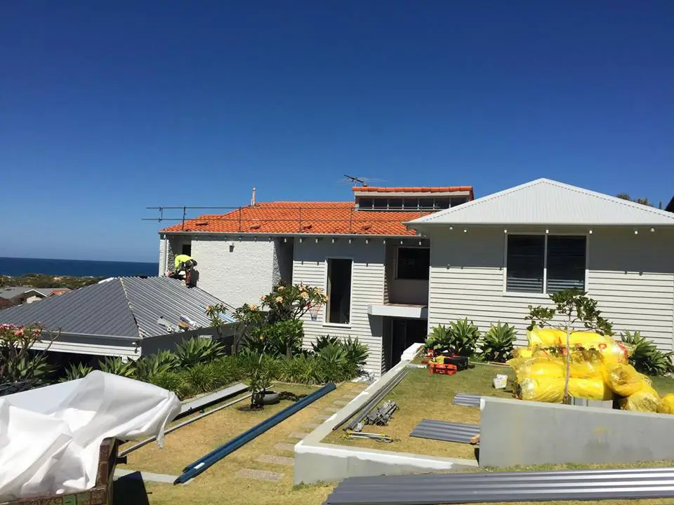 Metal roof replacement on a coastal home in Perth with roofing contractor installing new sheets