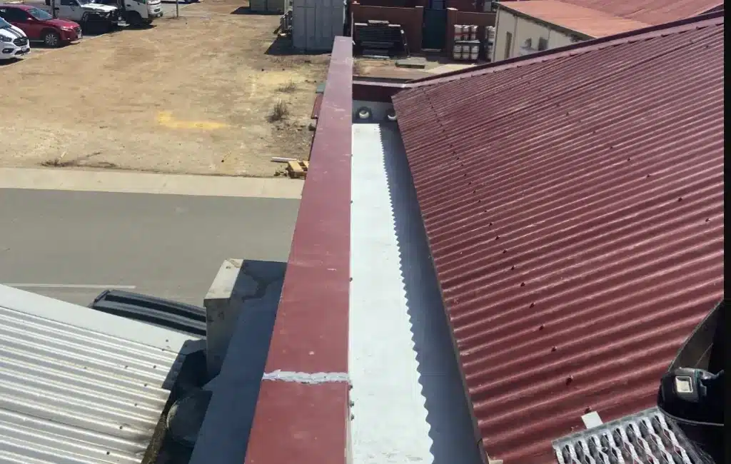 Commercial metal roof with box gutter system in Perth prepared for gutter guard installation to prevent debris buildup and improve drainage