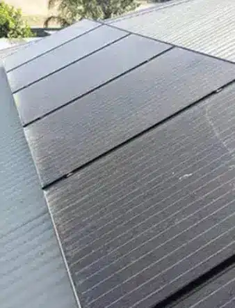 Dirty solar panels on a residential roof in Perth showing dust buildup before professional solar panel cleaning