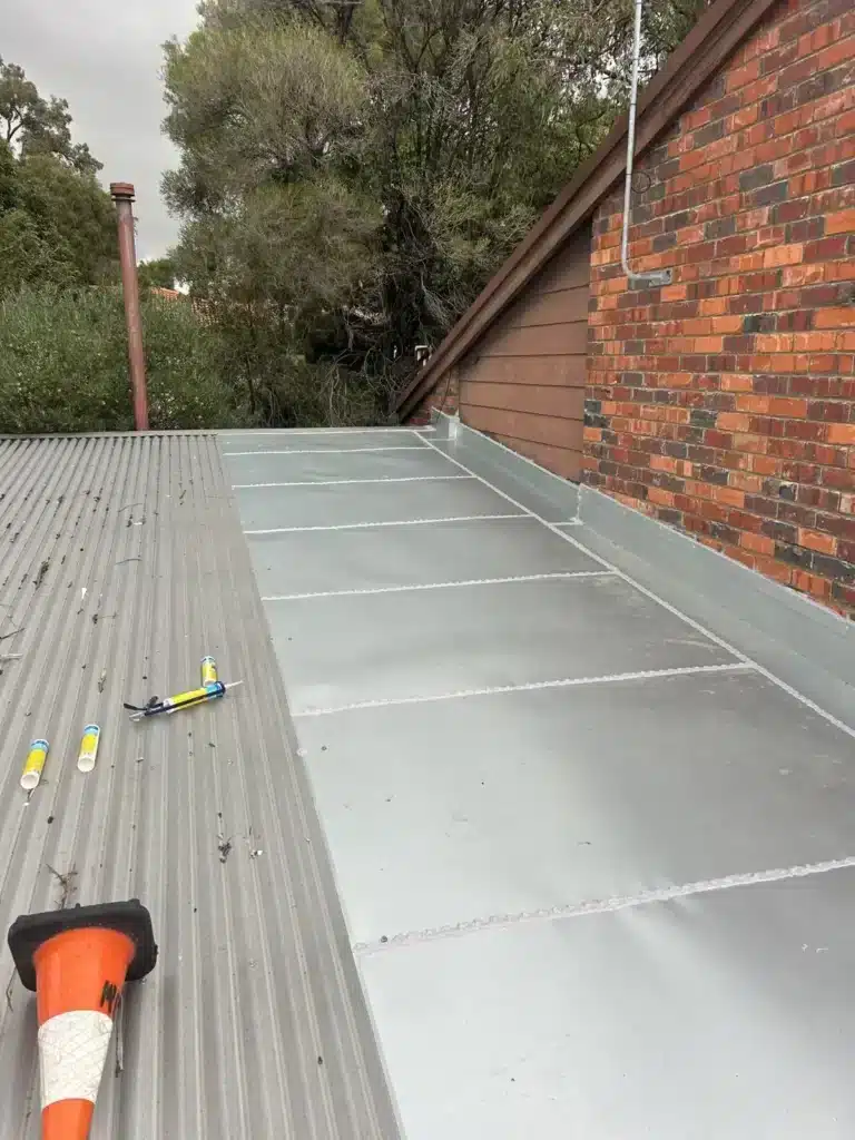 New metal roof sheets and flashing installed during a roof replacement in Perth