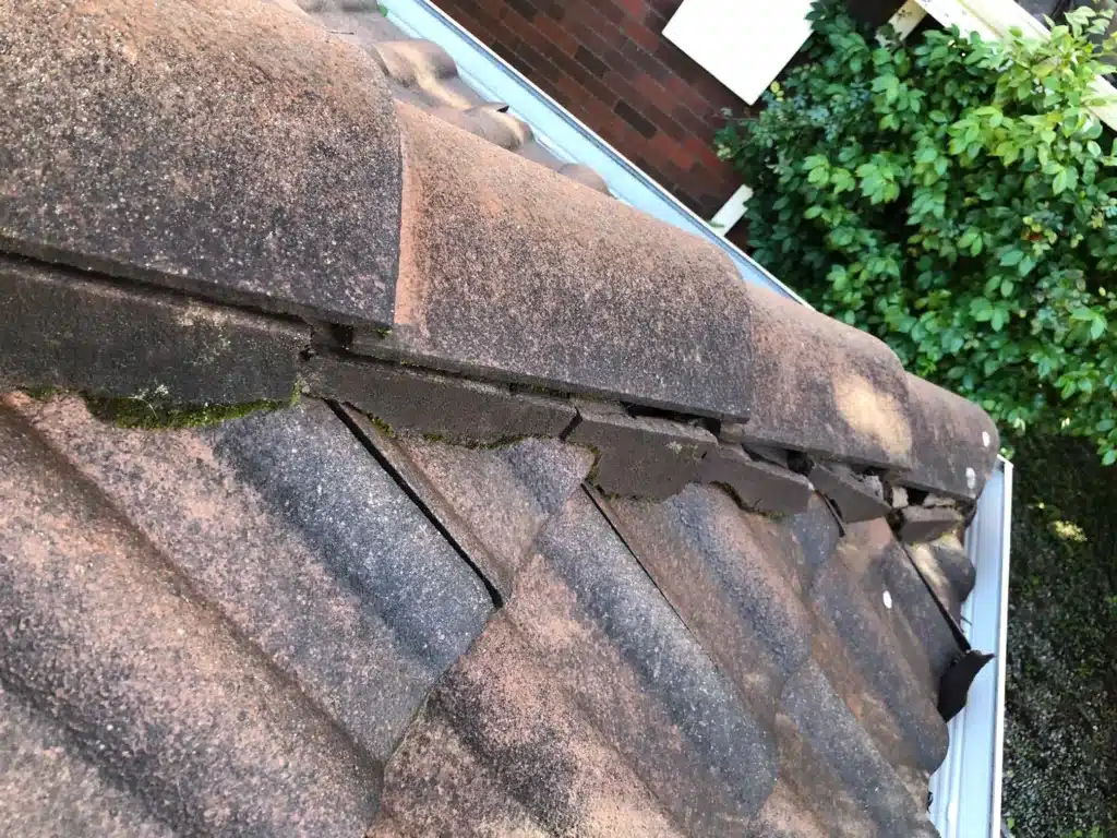 Cracked ridge capping and deteriorating mortar on tiled roof in Perth needing repointing