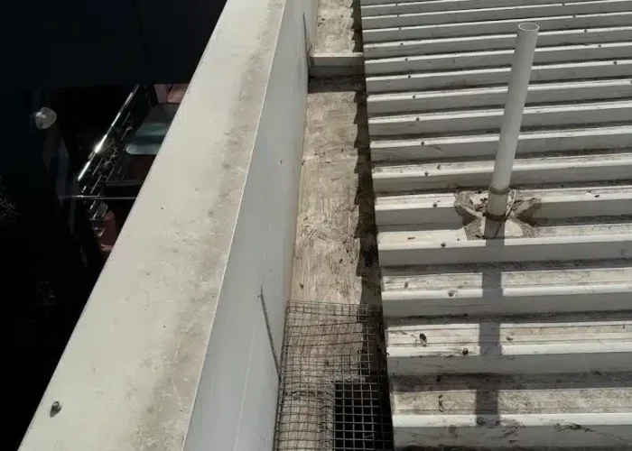 Commercial box gutter cleaning and maintenance completed by Insulmate Roofing Specialists.