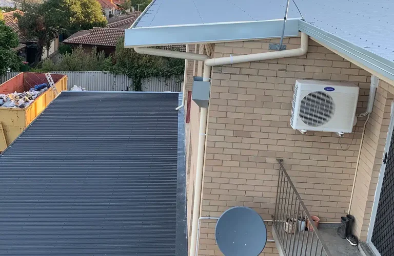 Roof plumbing Perth finished metal roof with gutter and downpipe installation on residential property